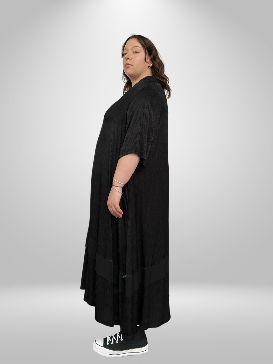 A curvy woman wearing the Cascading Layered Plus Size Maxi Dress with Collared Neckline, showcasing the trendy curvy fashion maxi dress in New Zealand