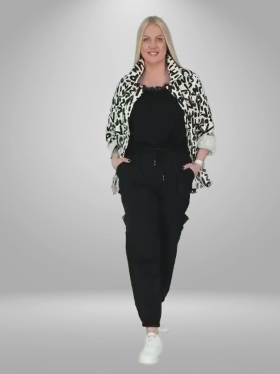 A video of curvy woman wearing stylish and comfortable 100% Cotton Divas Plus Size Jacket. Made from 100% cotton, this jacket is perfect for both casual and formal occasions. Its luxurious feel and perfect fit make it a must-have in your wardrobe. Shop now!