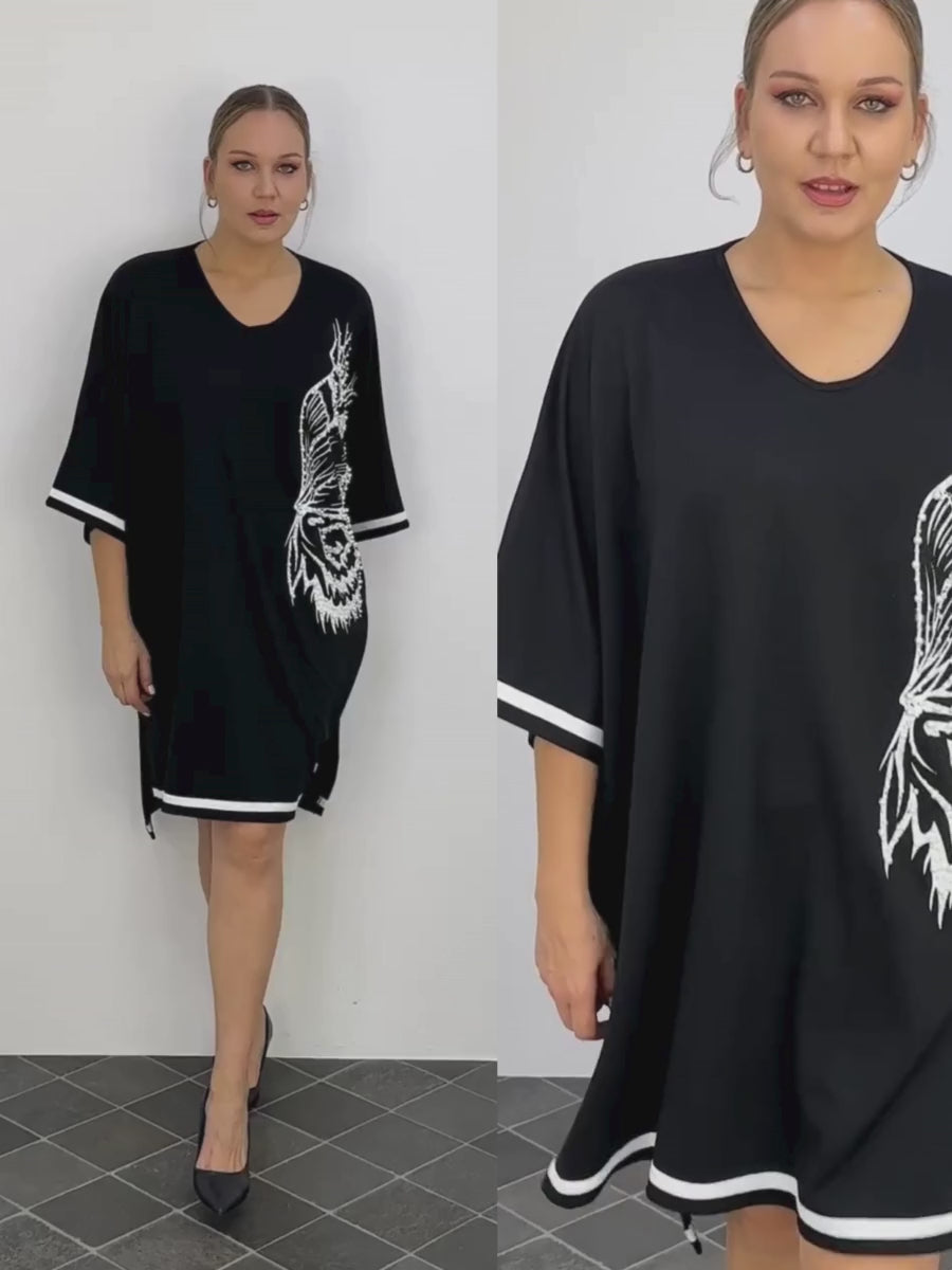 A video featuring a curvy model confidently strutting in the Darkwin Pearl Butterfly Plus Size Dress, highlighting its flattering fit and stylish design for curvy women in New Zealand.