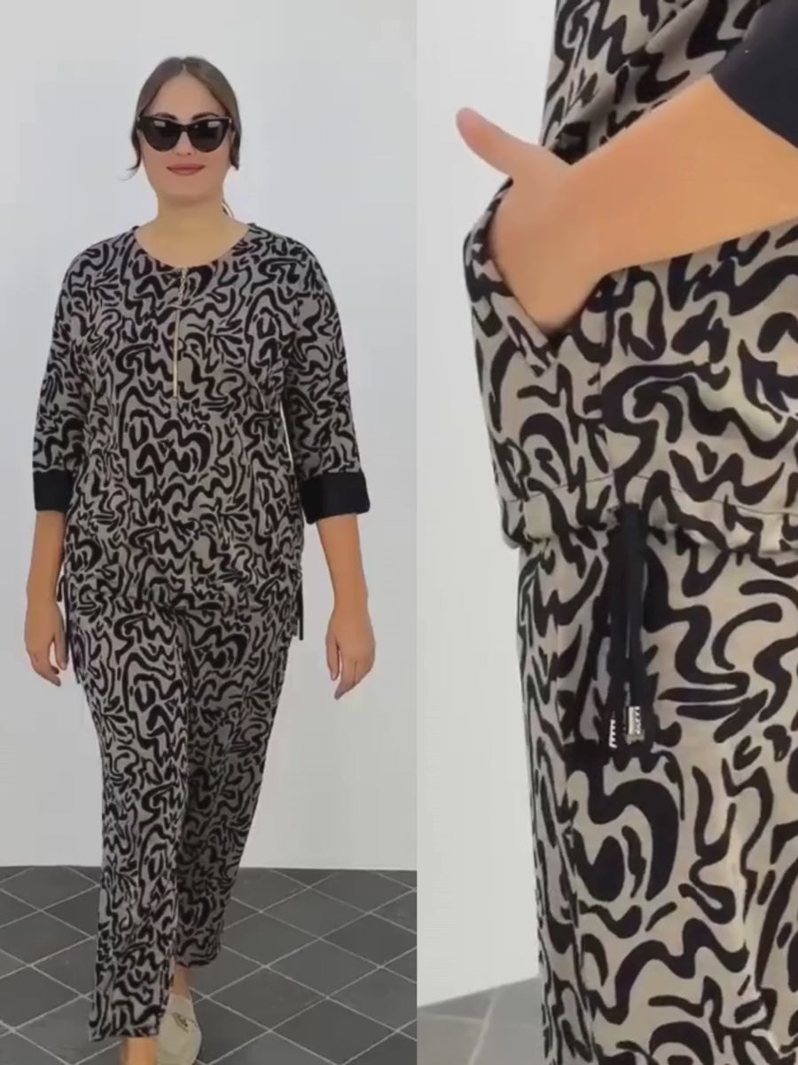 Introduction video of the Darkwin Abstract Print Pants, focusing on their flattering fit for sizes 18-20 and zooming in on the fabric's texture and vibrant print to highlight the blend of comfort and high-fashion style.